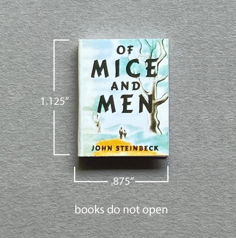May include: A miniature hardcover book titled "Of Mice and Men" by John Steinbeck. The cover features a painting of a tree and two figures walking in a landscape. The book measures 1.125 inches tall and .875 inches wide.