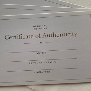 May include: A white certificate of authenticity for original artwork. The certificate has the text "Original Artwork" and "Certificate of Authenticity" printed in gold. The certificate has blank lines for the artist's name, artwork details, and signature.