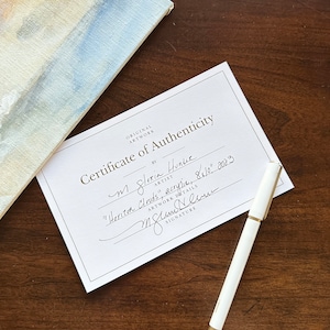 May include: A white certificate of authenticity with black text that reads "Original Artwork Certificate of Authenticity by M Gloria Hunlue Artist "Horizon Clouds", acrylic, 84" x 10", 2003" and a handwritten signature.