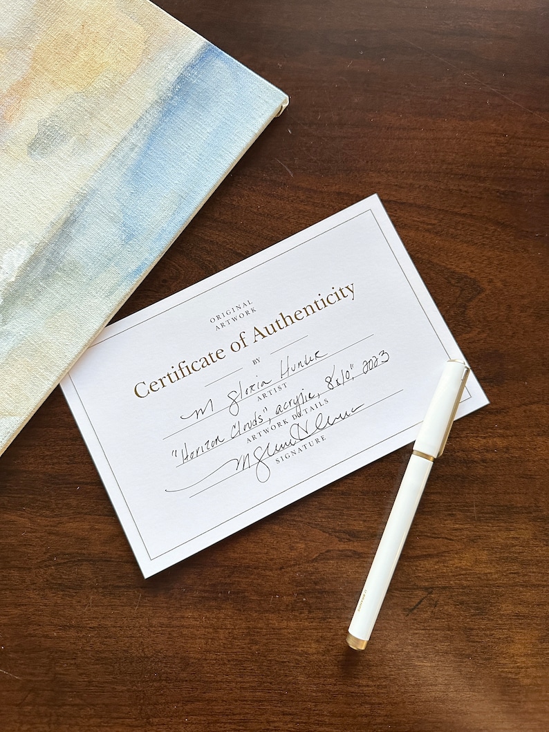 May include: A white certificate of authenticity with black text that reads "Original Artwork Certificate of Authenticity by M Gloria Hunlue Artist "Horizon Clouds", acrylic, 84" x 10", 2003" and a handwritten signature.