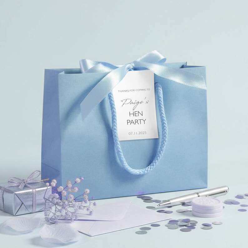 Personalised hen party gift bags with custom tags and ribbons, perfect for adding a special touch to hen do favours. Made from 100% recycled paper with reinforced bases and soft rope handles, these elegant bags can be customised with names, dates, or messages. Ideal for presenting gifts or party favours in style.