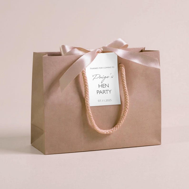 Personalised hen party gift bags with custom tags and ribbons, perfect for adding a special touch to hen do favours. Made from 100% recycled paper with reinforced bases and soft rope handles, these elegant bags can be customised with names, dates, or messages. Ideal for presenting gifts or party favours in style.