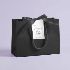 Personalised hen party gift bags with custom tags and ribbons, perfect for adding a special touch to hen do favours. Made from 100% recycled paper with reinforced bases and soft rope handles, these elegant bags can be customised with names, dates, or messages. Ideal for presenting gifts or party favours in style.