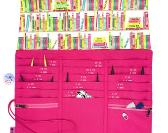 May include: A hot pink knitting needle organizer with a colorful bookshelf pattern at the top. The organizer has multiple pockets for needles of various sizes, ranging from US size 2 (2.75 mm) to US size 15 (10 mm). The text "Fly Yarns" is printed on the bottom.