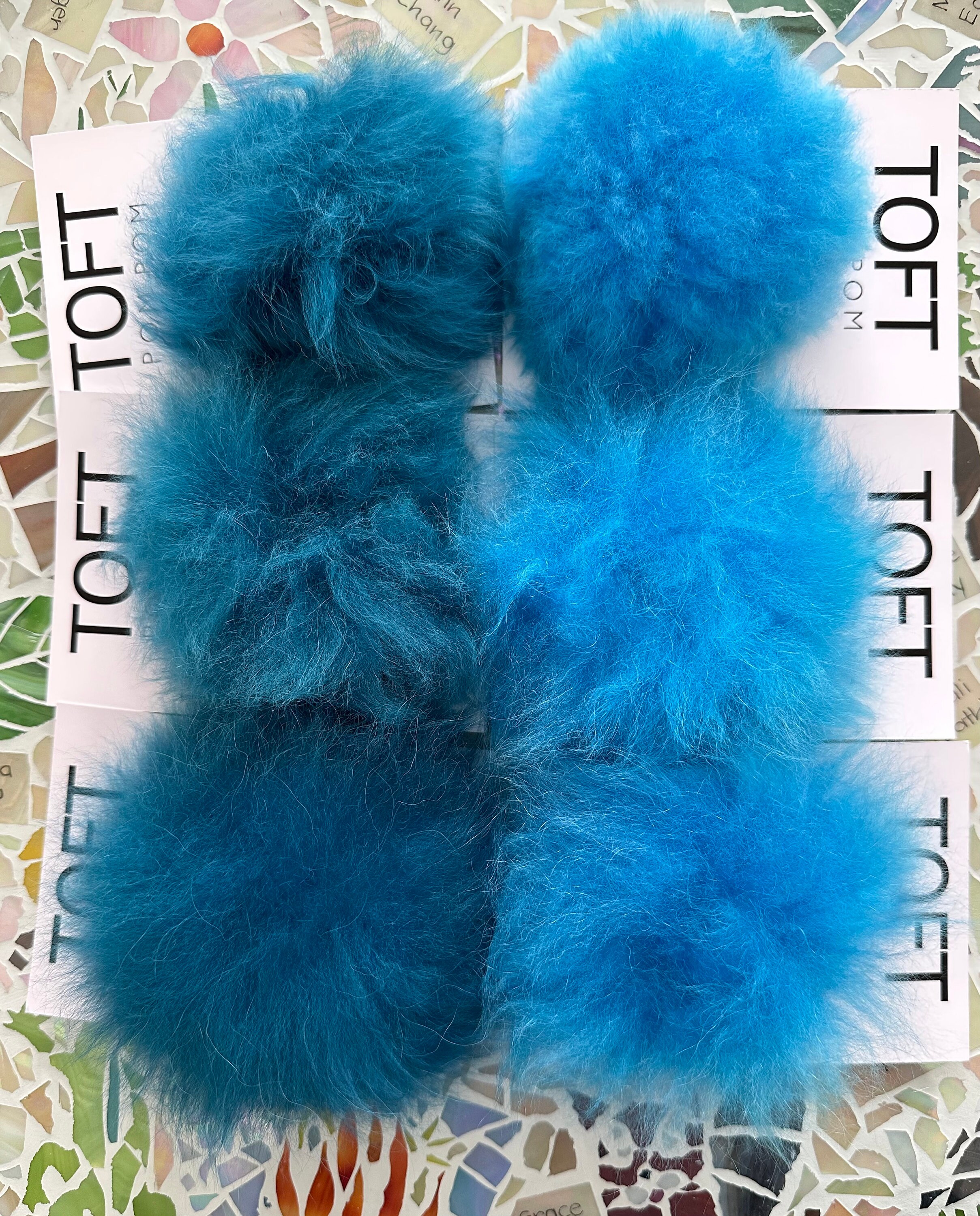 Choose a Colorful Toft Pom Pom made from Alpaca Fur which has a snap to sew  on to your knitwear. Snap on and off for washing or to change the look  of