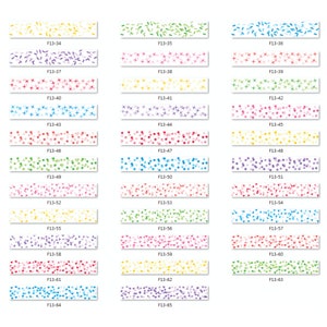 May include: A collection of decorative washi tapes with various colorful patterns. Designs include confetti, stars, hearts, and geometric shapes in shades of yellow, green, pink, blue, and purple. Each tape is labeled with a unique code, such as F13-34.