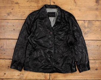 May include: A black leather jacket with a button closure and two pockets. The jacket has a slightly wrinkled texture.