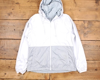 May include: A white and light gray hooded jacket with a zipper closure. The jacket has a contrasting color design with a white top and a light gray bottom.