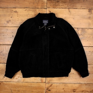 May include: A black suede jacket featuring a high collar, a front zipper closure with a snap button flap, and two side pockets. The interior label displays the text "Basic Editions". The jacket has long sleeves with ribbed cuffs and a ribbed hem.