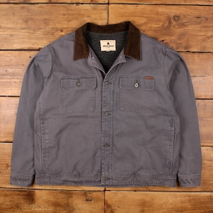May include: A gray jacket with a brown corduroy collar and a fleece lining. The jacket has two chest pockets and two lower pockets. The brand "Woolrich" is visible on a tag on the collar.