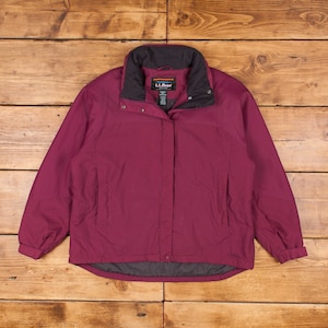 May include: A burgundy zip-up jacket with a black collar and a black zipper. The jacket has a logo that says "L.L.Bean" on the left side of the chest.