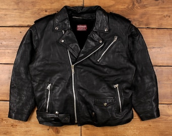 May include: Black leather jacket with silver zippers, a notched collar, and a belt at the waist. The jacket has multiple pockets and the word "HARVARD" on a small tag. A classic biker style.