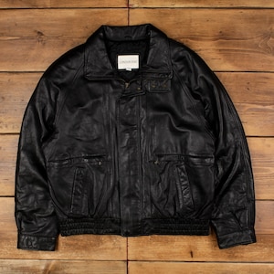 May include: Black leather jacket with a collared neckline, two front pockets, and a zip closure. The jacket has a ribbed hem and cuffs. The label reads "LONDON FOG".