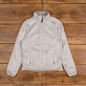 May include: A light gray fleece jacket with a zipper closure and the North Face logo on the left chest.
