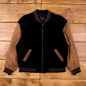May include: Black bomber jacket with brown suede sleeves and brown trim on the cuffs, collar, and waist. The jacket has a zipper closure and two front pockets. The jacket has a tag that says "4S".