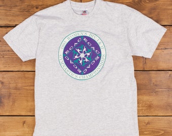 May include: Gray t-shirt with a purple and teal circular graphic that says "1995 Women's Div I & II ECAC Gymnastics Championships".