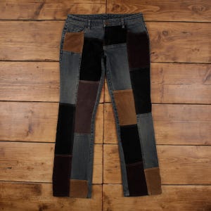 Könnte beinhalten: Blaue Jeans mit Patchwork-Einsätzen in Braun-, Schwarz- und Grautönen. Die Jeans haben ein klassisches Fünf-Taschen-Design und eine gerade Beinpassform. Der Patchwork-Look verleiht dem Kleidungsstück einen einzigartigen, Vintage-inspirierten Look.