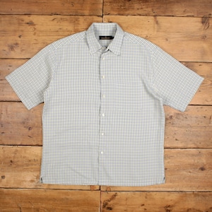 May include: A short-sleeved button-down shirt with a light blue and white checkered pattern. The shirt has a classic collar and a chest pocket. The fabric appears to be lightweight, suitable for warm weather.