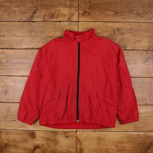 May include: A red zip-up jacket with a black zipper and a high collar.