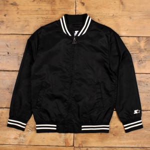 May include: Black satin bomber jacket with white stripes on the collar, cuffs, and hem. Features a full zipper closure and two front pockets. The Starter logo is visible on the sleeve.
