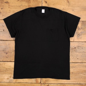 May include: A plain black t-shirt with a pocket on the chest. The top has short sleeves and a crew neck. A small white label is visible at the back of the neck. The material is a solid colour.