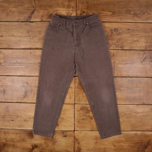 May include: A pair of brown high-waisted jeans with a straight leg.