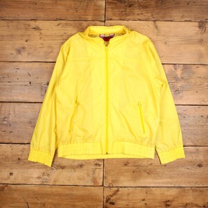 May include: A bright yellow lightweight jacket with a zipper closure and a stand-up collar.