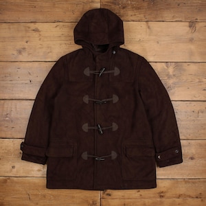 May include: A dark brown duffle coat featuring a hood, long sleeves with adjustable cuffs, and four toggle closures down the front. The coat includes two large front pockets with flaps and is constructed from a solid, textured fabric material.