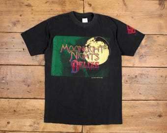 May include: Black t-shirt with a graphic print of a moon and the text "Moonlight Nights Belize Tropical Adventure".