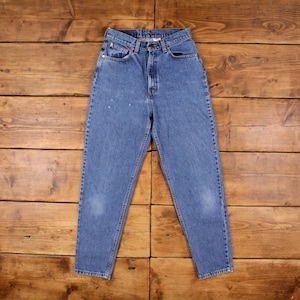 May include: A pair of light blue denim jeans with a high waist and a straight leg. The jeans have a classic five-pocket design and a button fly.