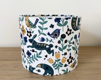 Lampshade or suspension made with a white blue green forest fabric with animals