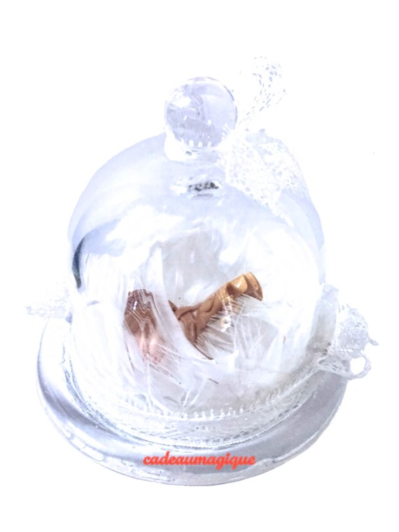 Glass bell with baby girl on bed of feathers: adorable deco