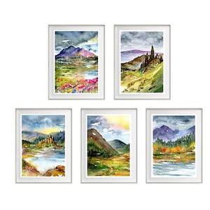 May include: Set of five watercolour paintings depicting various landscapes with mountains, rivers, and forests. The paintings are framed in white and feature a variety of colours, including green, blue, brown, and purple.