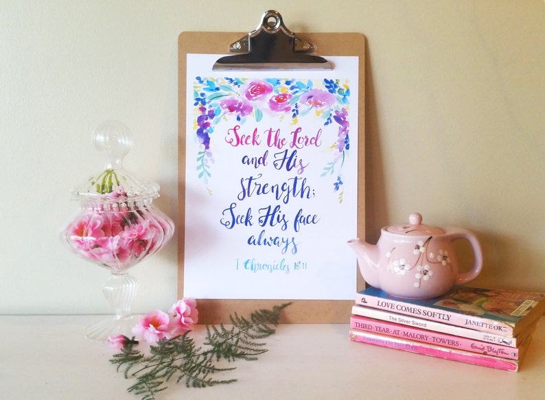 May include: A watercolor print with a floral border and the text "Seek the Lord and His Strength: Seek His face always" with the scripture reference "1 Chronicles 16:11".