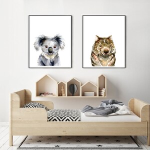May include: Two framed watercolor paintings of animals. The left painting features a koala, and the right painting features a wombat. Both paintings have a white background.