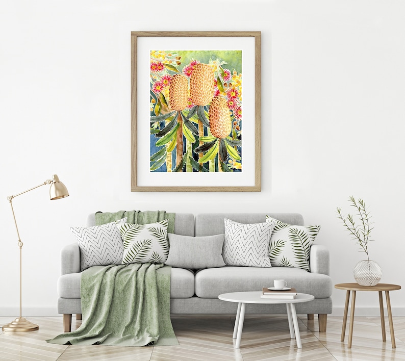 Print of a watercolour painting of 3 banksia flowers and leaves. Gum blossom is in the background.