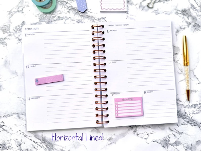 May include: Open notebook with horizontal lined pages, dated for February. Includes a gold pen and pink sticky notes. The notebook has a copper spiral binding. Text on the bottom of the page reads "Horizontal Lined".