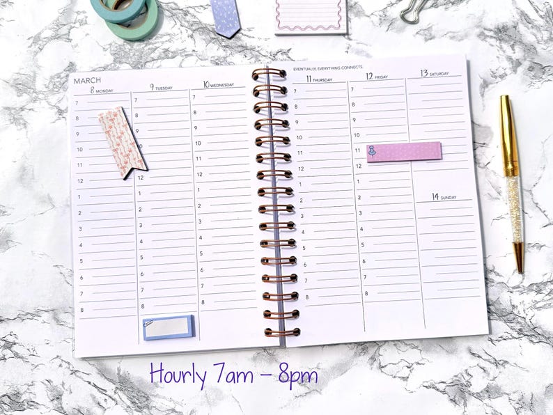 May include: An open spiral-bound planner with a white interior, featuring hourly time slots from 7 am to 8 pm. The planner has a gold pen, decorative tape, and sticky notes. The background is a marble pattern.