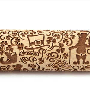 May include: A wooden rolling pin with a detailed design of Irish symbols, including shamrocks, a leprechaun, a pot of gold, a horseshoe, and the text "St. Patrick's Day".