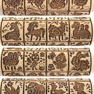 May include: A wooden rolling pin with a variety of animal designs carved into the surface. The designs include a rooster, a duck, a cow, a camel, a sheep, a bee, a butterfly, a rabbit, a goose, a bison, a goat, and a pig.