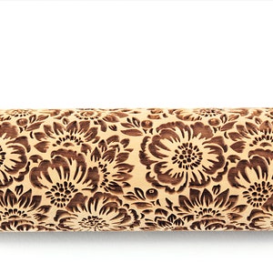 May include: A wooden rolling pin with a floral design carved into the surface. The design features intricate details of flowers and leaves.