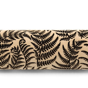 May include: A wooden rolling pin with a black fern pattern engraved on the surface. The rolling pin is designed for creating decorative patterns on dough.