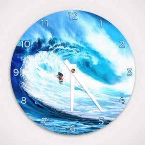 May include: A blue and white clock with a surfer riding a wave. The clock face has black numbers and a white hand.