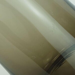 May include: A brown glass vase with a clear glass design. The vase has a rounded bottom and a wide opening.