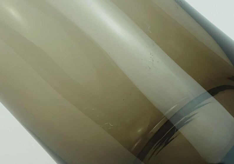 May include: A brown glass vase with a clear glass design. The vase has a rounded bottom and a wide opening.