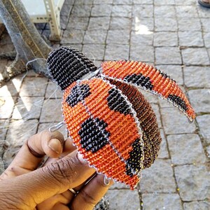 Glass beads Red and Black Ladybug with wings open. Custom colors also welcome. Made by Job Guwhe, Express Shipping Worldwide