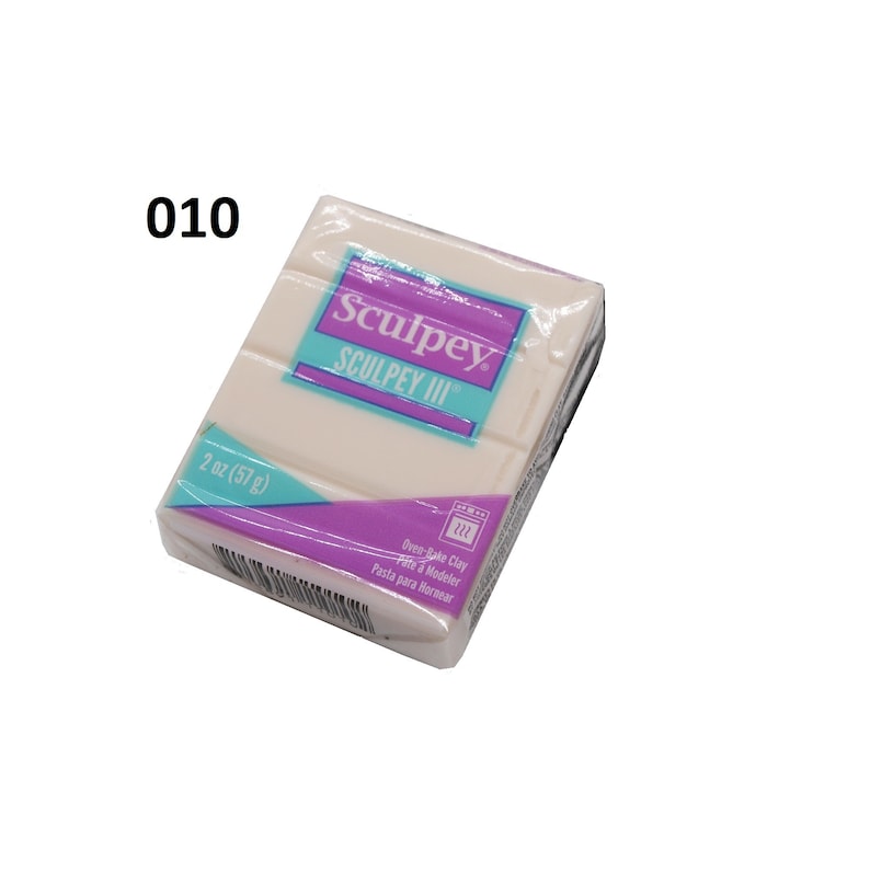 May include: A 2 ounce (57 gram) package of white Sculpey III oven-bake clay. The package is purple and blue with the text "Sculpey III" and "Oven-Bake Clay" printed on it.