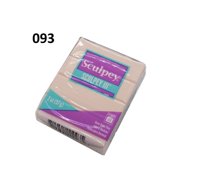 May include: A 2 ounce (57 gram) package of Sculpey III oven-bake clay. The package is pink and white with the Sculpey logo and the words "Oven-Bake Clay" and "Pasta para Hornear".