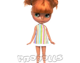 May include: A doll with orange hair in pigtails wearing a white dress with colorful stripes and pink shoes.