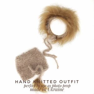 May include: Hand-knitted baby outfit in beige with a fluffy brown headband. The outfit is perfect to use as a photo prop and is made in Ukraine.